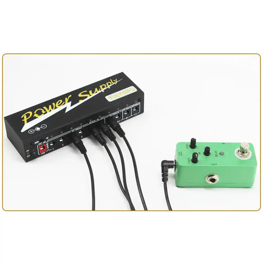 DC power cable for guitar pedals connected to a power supply and a green effects pedal. Features 5.5 x 2.1mm connectors and durable 24AWG copper wire.