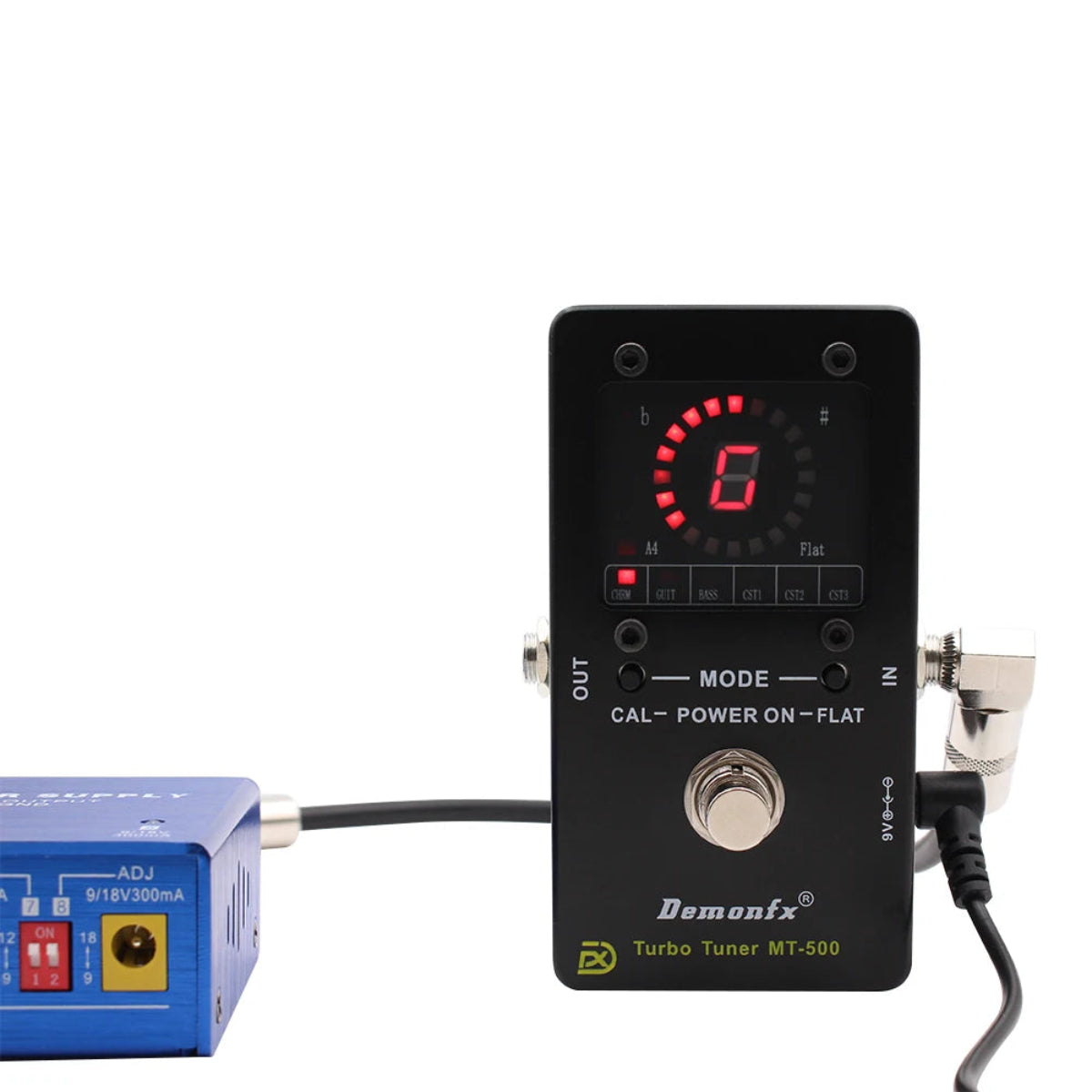 Demonfx Turbo Tuner MT-500 Strobe Tuner for all instruments with LED display and mode selector, connected to power supply and guitar input.