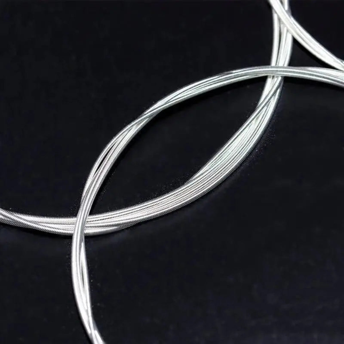 Orphee NX35 classical guitar strings with a nylon core and silver wound design, offering hard tension for rich tone and durability.