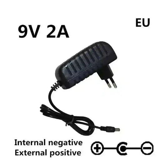 Pedal Power Supply Adapter AC 100-240V DC 9V 2A with EU plug. Features internal negative and external positive polarity for musical instruments.